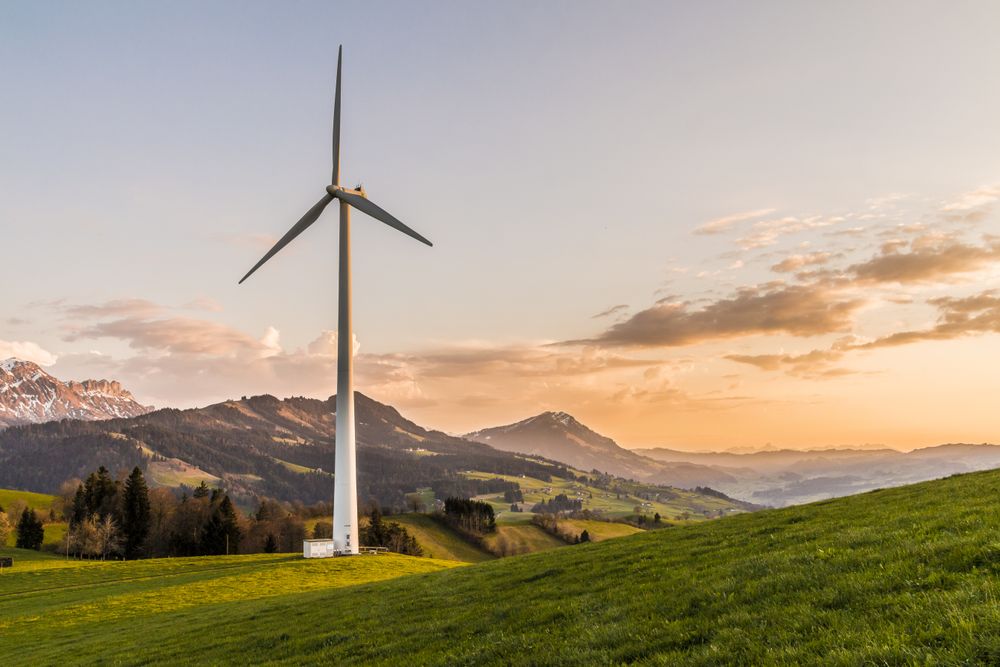 Éolienne au coucher du soleil dans un paysage de montagne